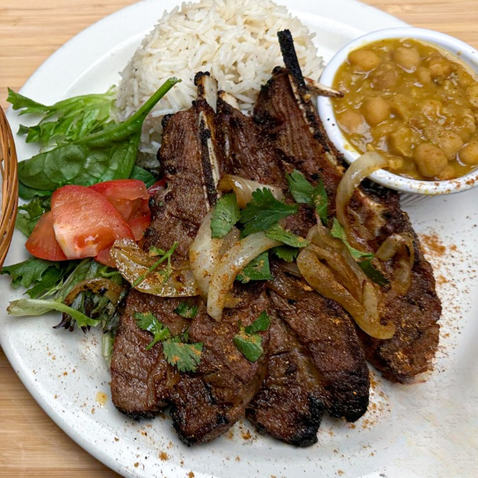 Grilled lamb chops with rice, salad, and a side of beans at Tulip Grill.